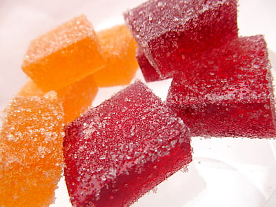 red and orange candies on white surface