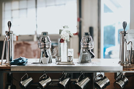 two gray coffee makers on table
