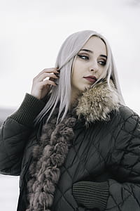 woman in black bubble jacket with white hair posing for photo