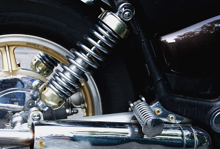 closed up photo of silver motorcycle coilover