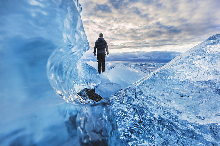 person wearing gray hoodie and black pants standing on ice