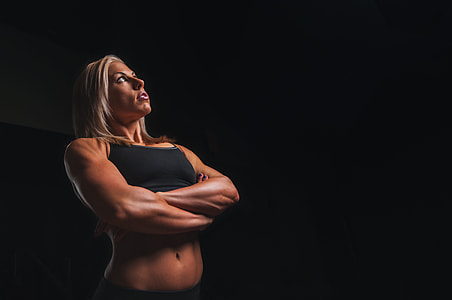 woman in black sports bra staring upward