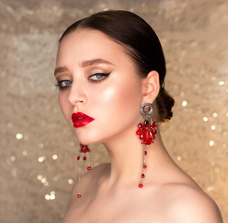 woman wearing red chandelier earrings