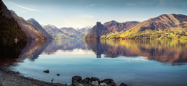 landscape photography of body of water surrounded by mountains during day time