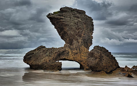 rock formation under cloudy sky at daytime