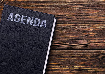 Agenda book on brown wooden surface