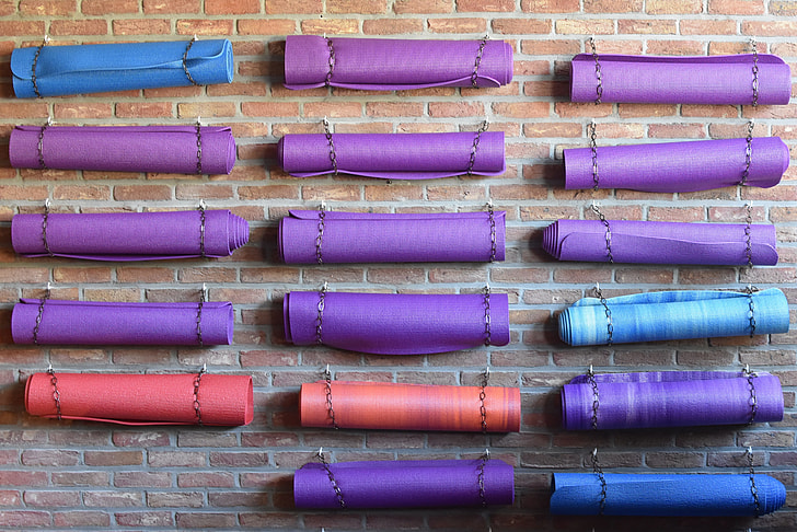 assorted-color rolled yoga mats