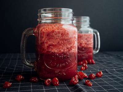 Mason Jar Filled With Cranberry Juice On Black and White Checked Cloth