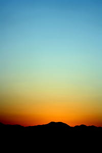 Silhouette of Mountain Under Orange and Blue Sky during Sunset