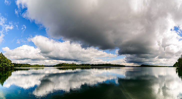 reflective photography of clouds and body of water