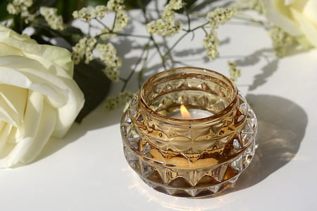 white tealight candle in glass container