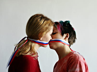 two woman kissing each other
