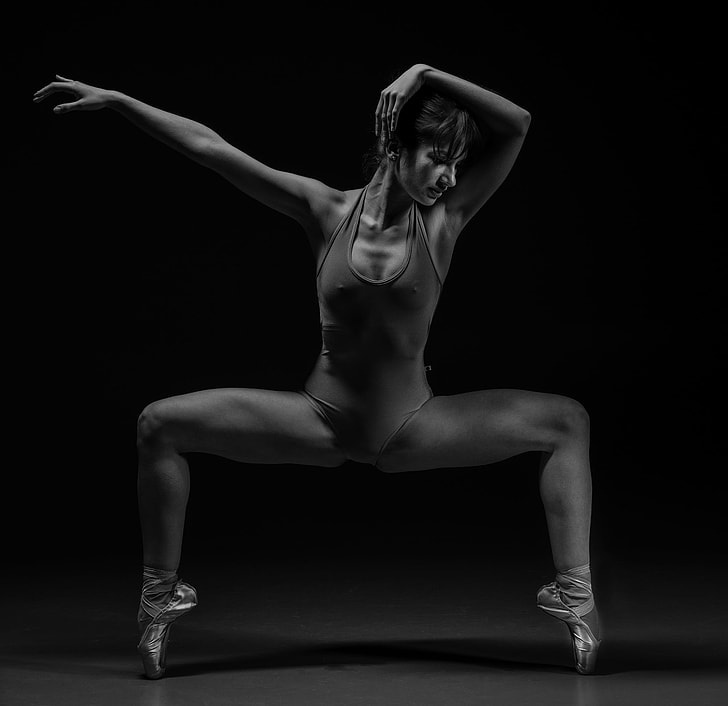 grayscale photography of Woman in leotard making post