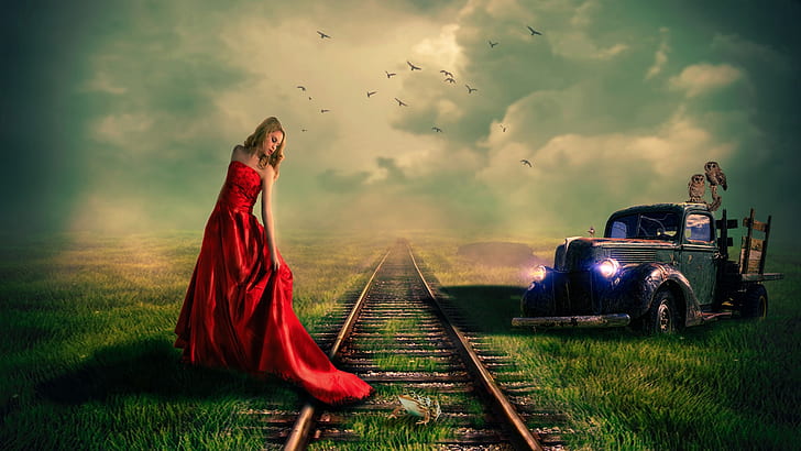 woman in red sleeveless dress standing beside train rail