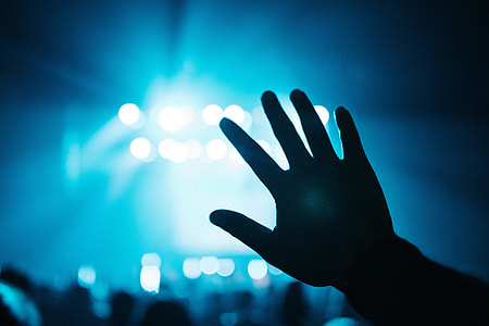 Man raising his hand a music concert party