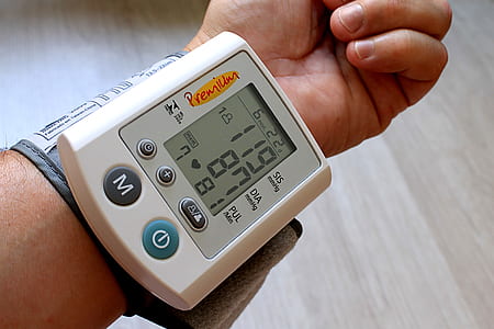 digital blood pressure monitor showing 119/87