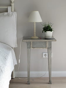 white table lamp on the top of grey wooden side table