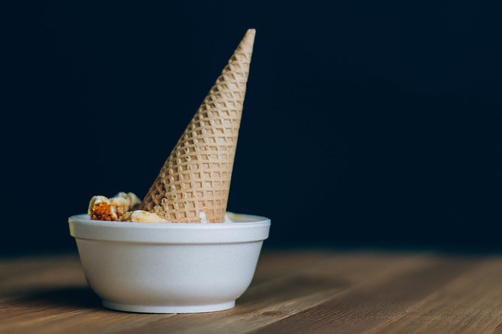 brown ice cream cone dipped on white ceramic bowl