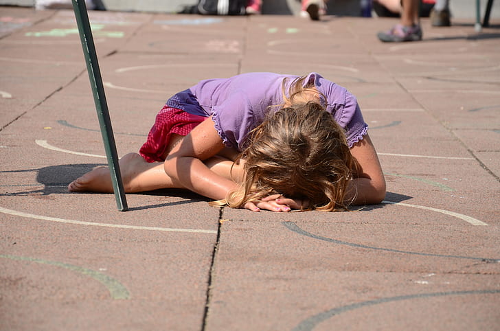 girl in purple shirt planking on floor
