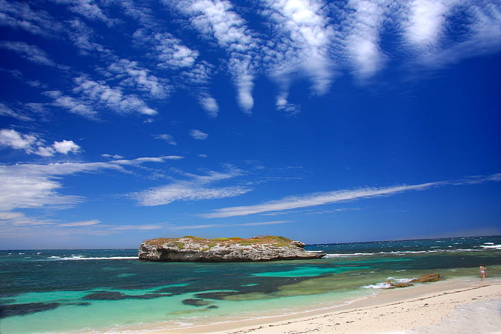 islet under blue sky and white clouds