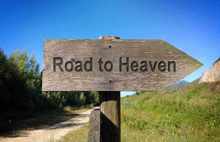 grey wooden Road to Heaven signage
