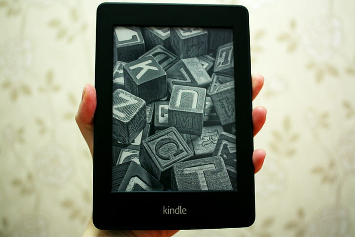 person holding black Kindle E-boor reader