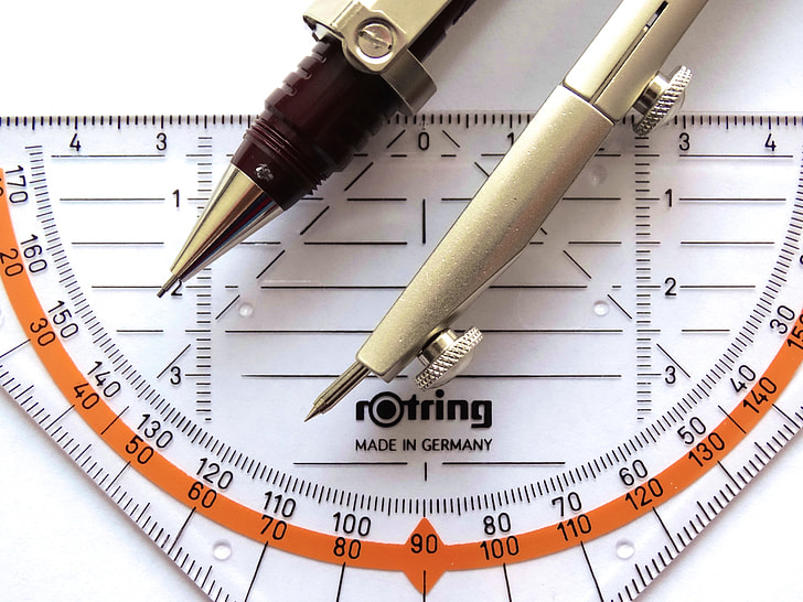 silver drafting compass on Rotring measuring tool