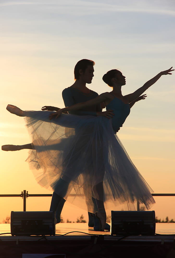 male and female ballerinas during sunset