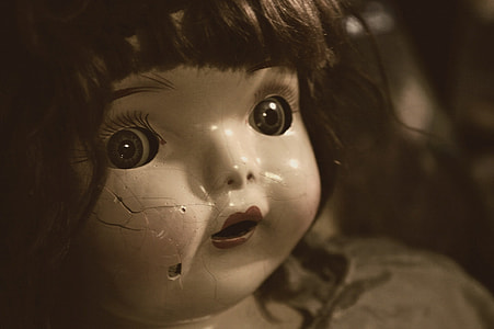 black haired doll with cracks