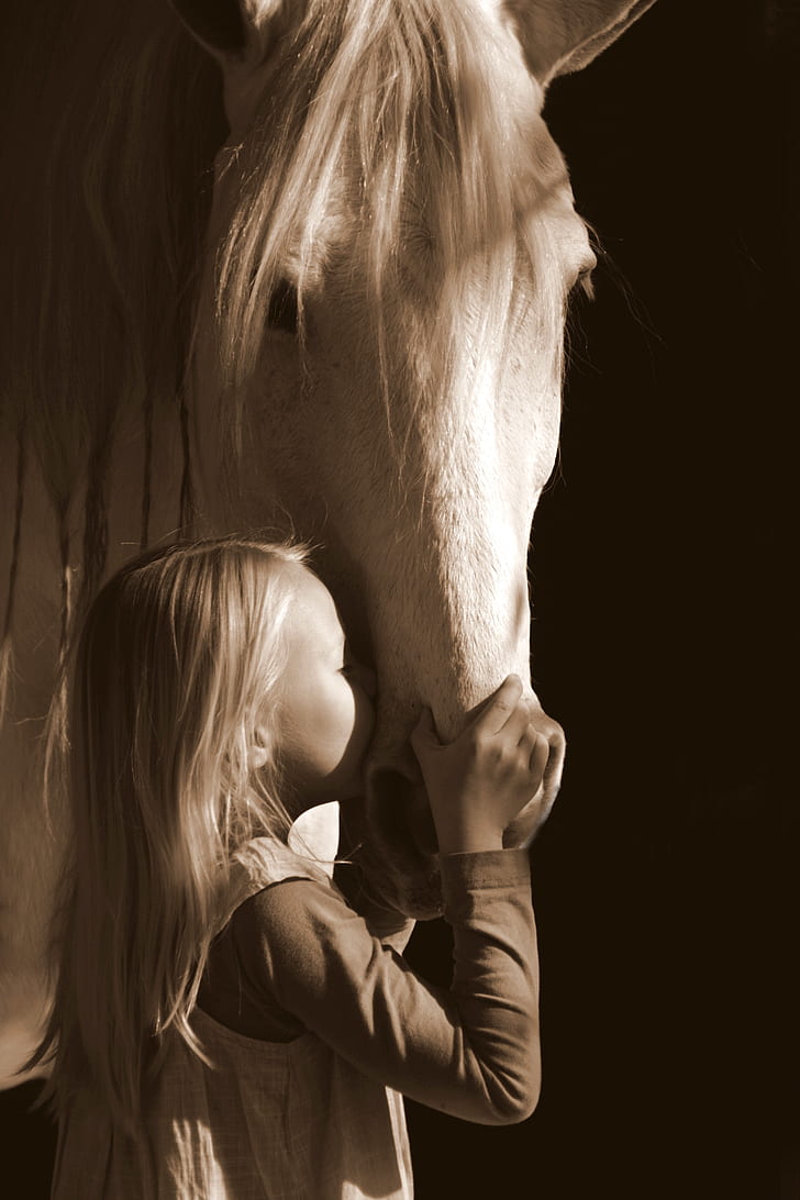 girl kissing white horse