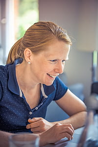 woman in blue polo shirt smiling