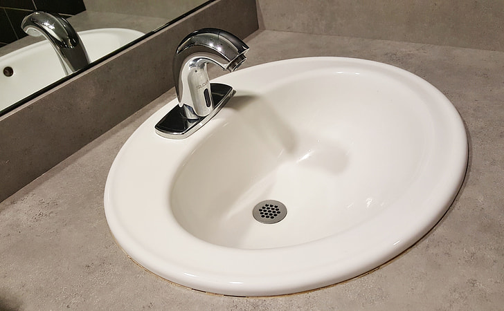 white ceramic sink and silver stainless steel faucet