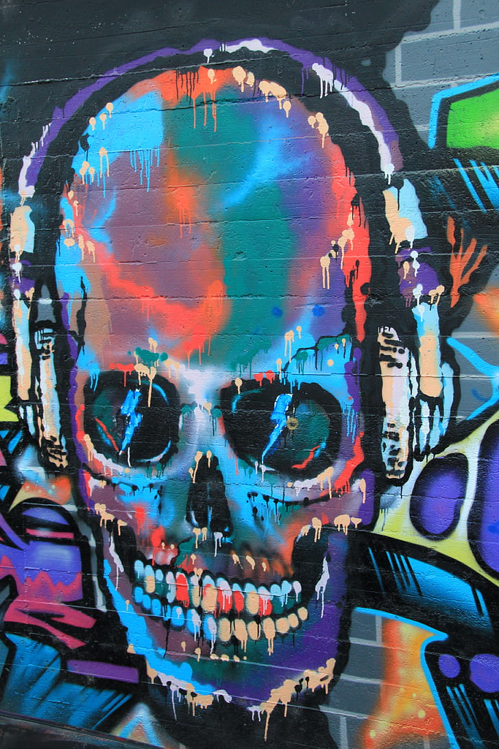 multicolored graffiti art of skull wearing headphones
