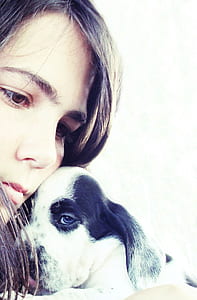 portrait photography of woman and white and black puppy