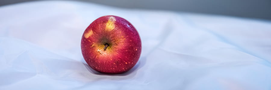 Red Apple Fruit on White Textile