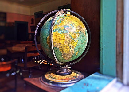 blue and yellow desk globe inside room