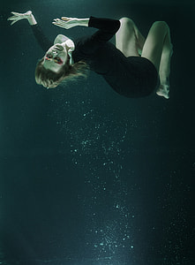 woman wearing black shirt in body of water