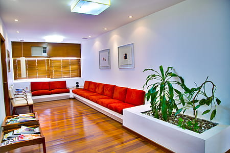 white wooden couches with red pads