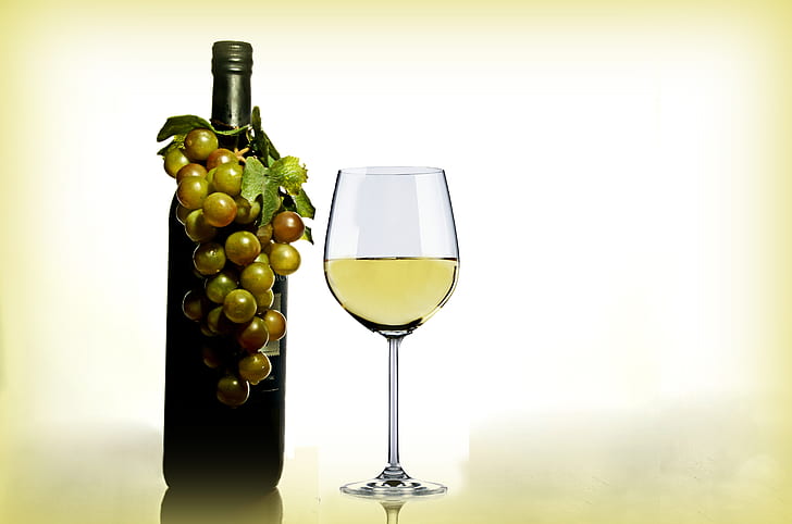 Wine in Wine Glass Near Green Glass Bottle