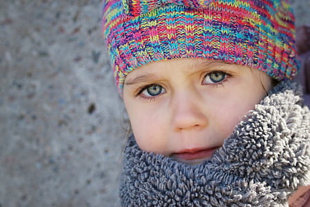 closeup photo of child in gray scarf