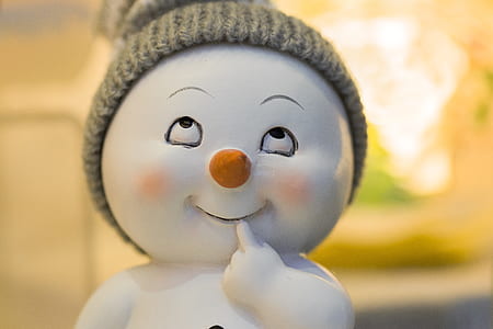 white and orange thinking baby snowman ceramic figurine