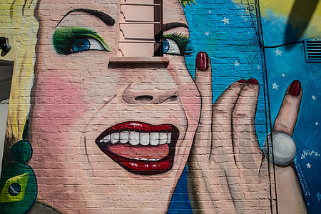 Street art depicting a woman smiling captured on a wall in Camden, Central London. Image taken with a Canon 6D