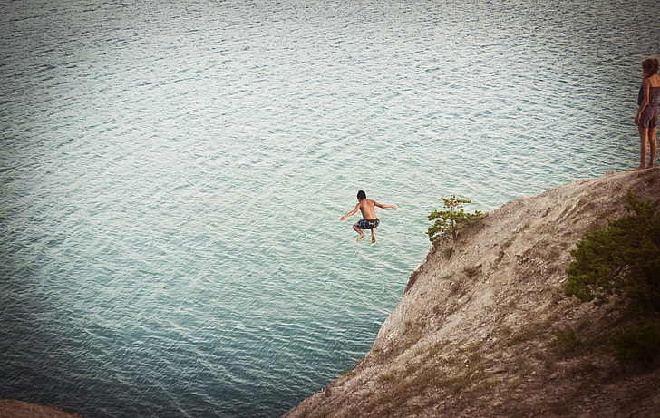 man jumped on cliff to water