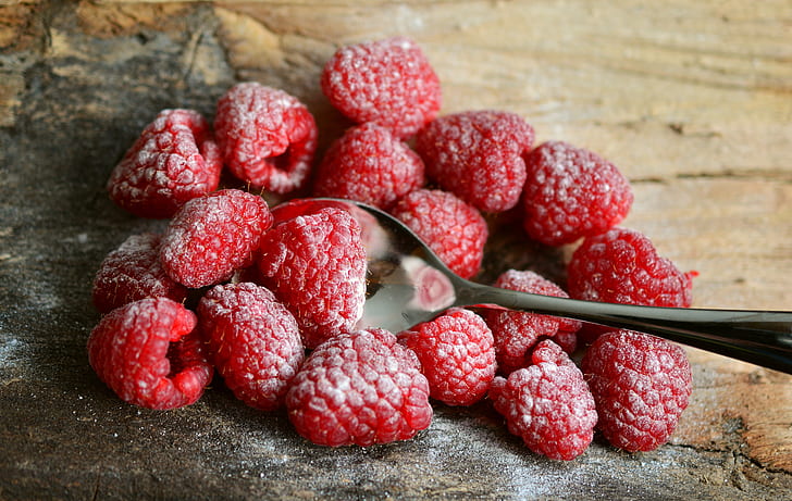 raspberries on brown surface