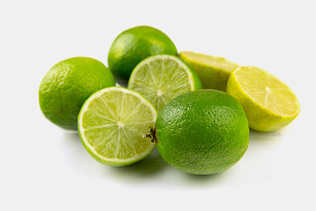Fresh lime fruits sitting on a plain white background, image captured with a Canon 6D
