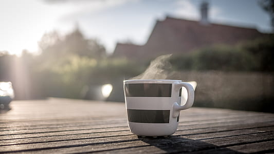 selective focus photo of ceramic mug with hot liquid