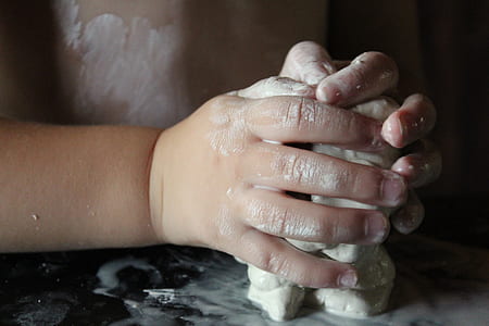 toddler's holding white clay