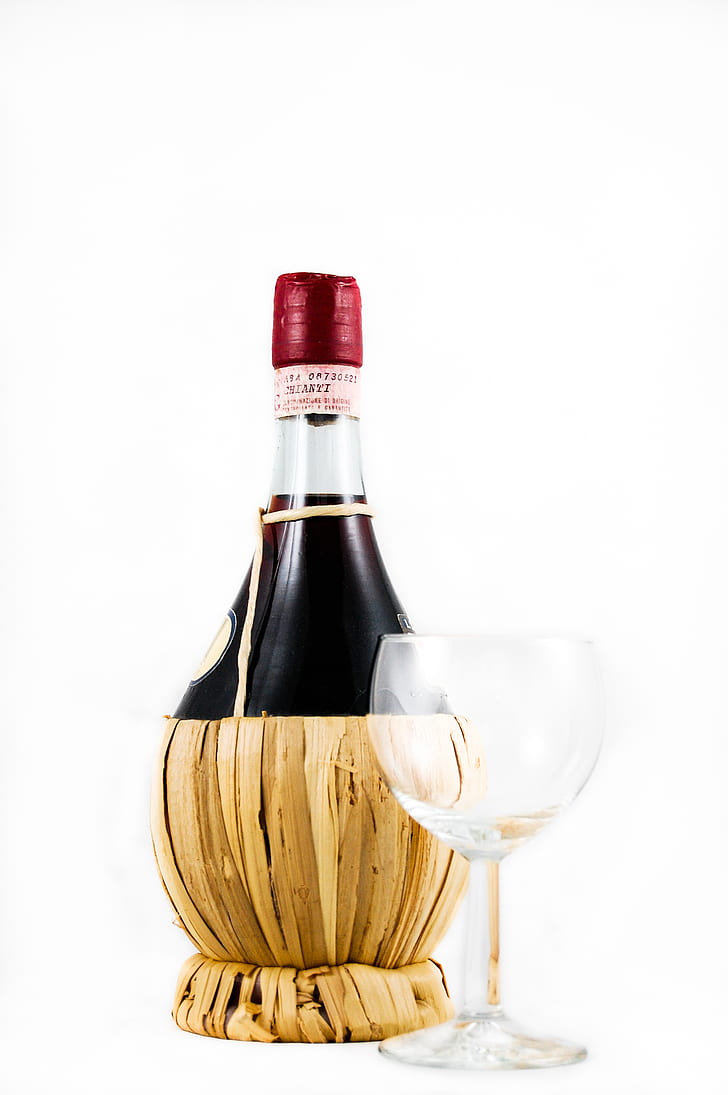 Clear Wine Glass Beside Red Wine Bottle