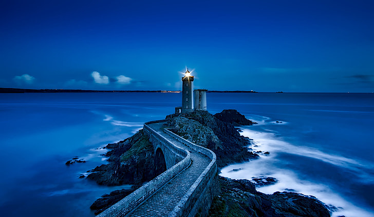 photo of lighthouse near sea