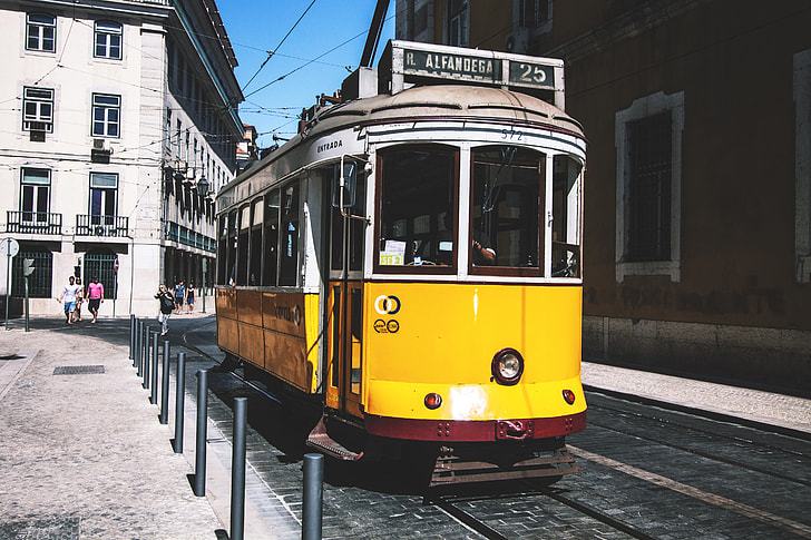 A yellow tram on the streets of Lisbon in Portugal